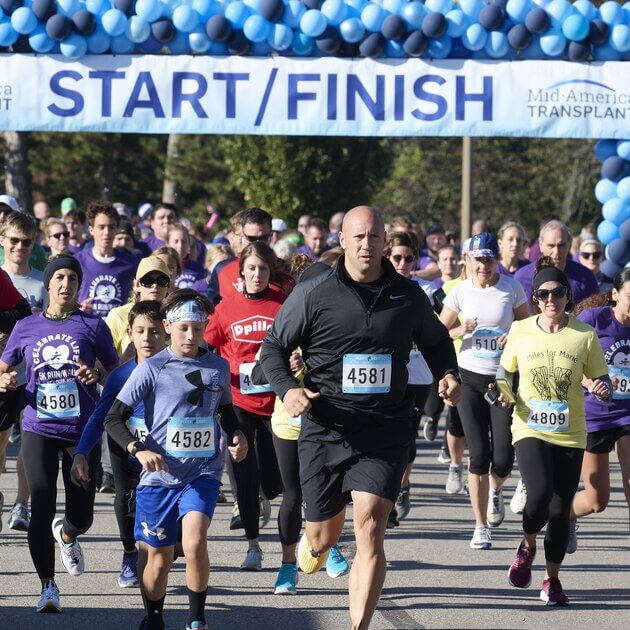 A large group of people running at the start of a 5k