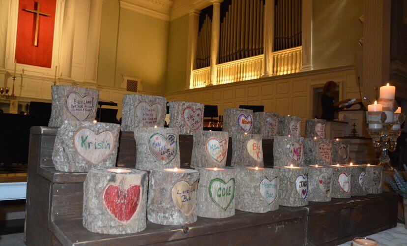 Families decorated candles in memory of their loved ones
