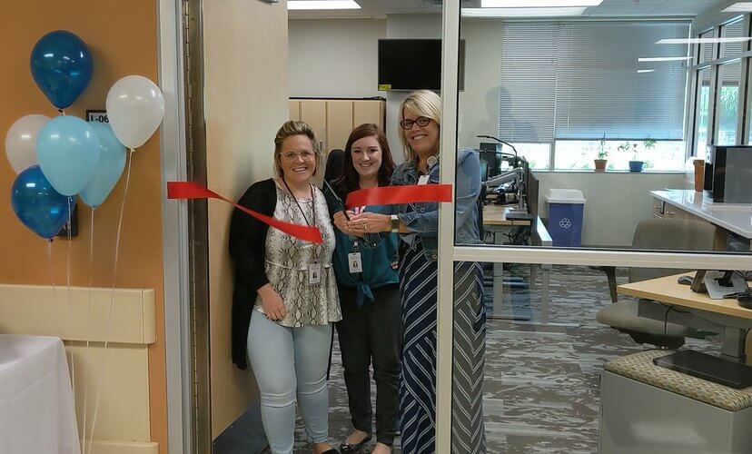 Mid-America Transplant's Manager of Donor Services Sarah Berger, right, cuts the ribbon with Donor Services team members to official open their new work space.  