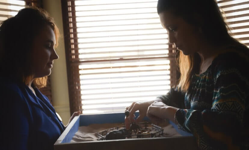 A counselor uses a sand tray in a counseling session.