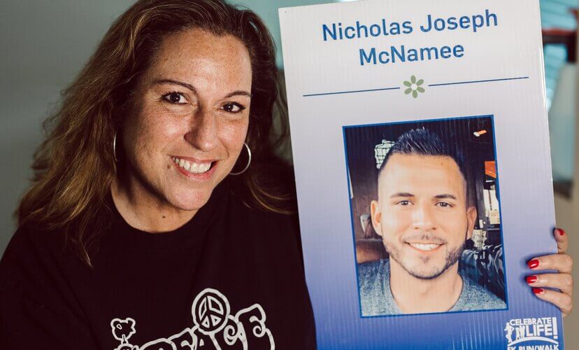 Gina Biancardi poses with a photo of her son, Nick
