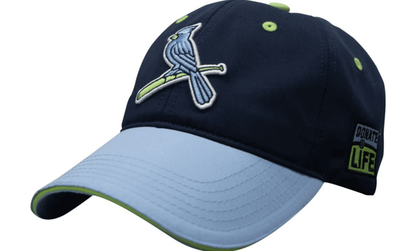 Dark blue baseball cap with light blue bill. A light blue St. Louis Cardinals logo on the front, with the Donate Life logo on the side.