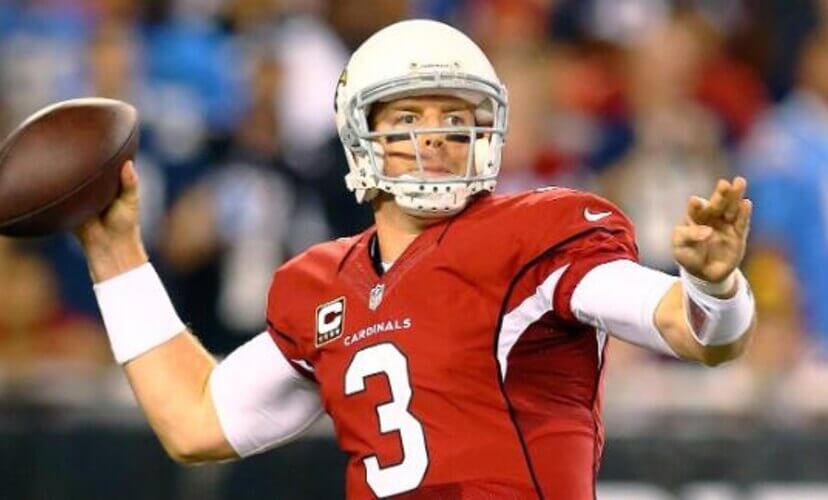 Carson Palmer throws a football