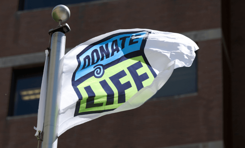 A flag with the Donate Life logo on it waves in the wind