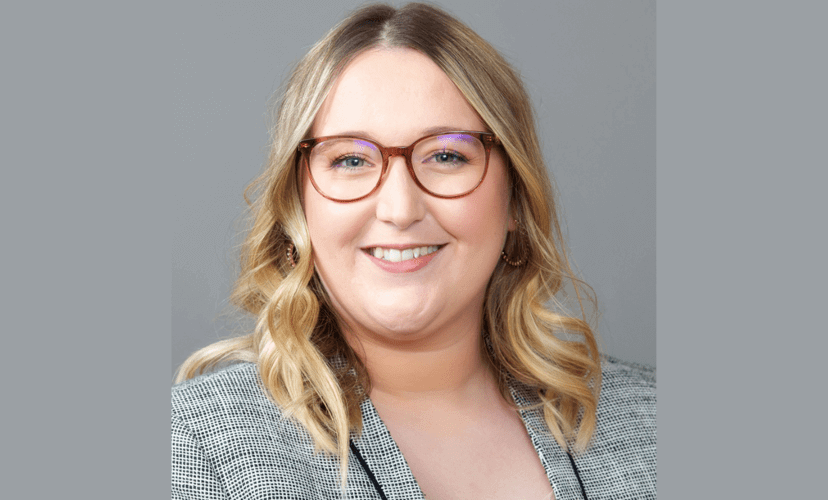 Ashley, Talent Business Partner at Mid-America Transplant. She has blonde hair and is wearing glasses and a grey suit jacket.