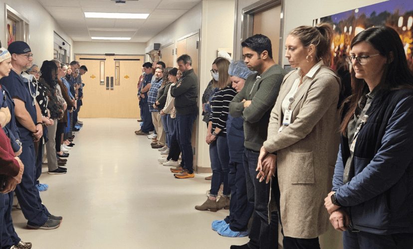 Employees line the halls to honor an organ donor as they are taken to the OR