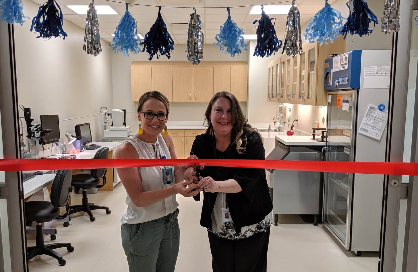 Ocular coordinator Savannaha Wiley, left, and lead ocular coordinator Kristene Clark officially open the new Mid-America Transplant Eye Bank. 