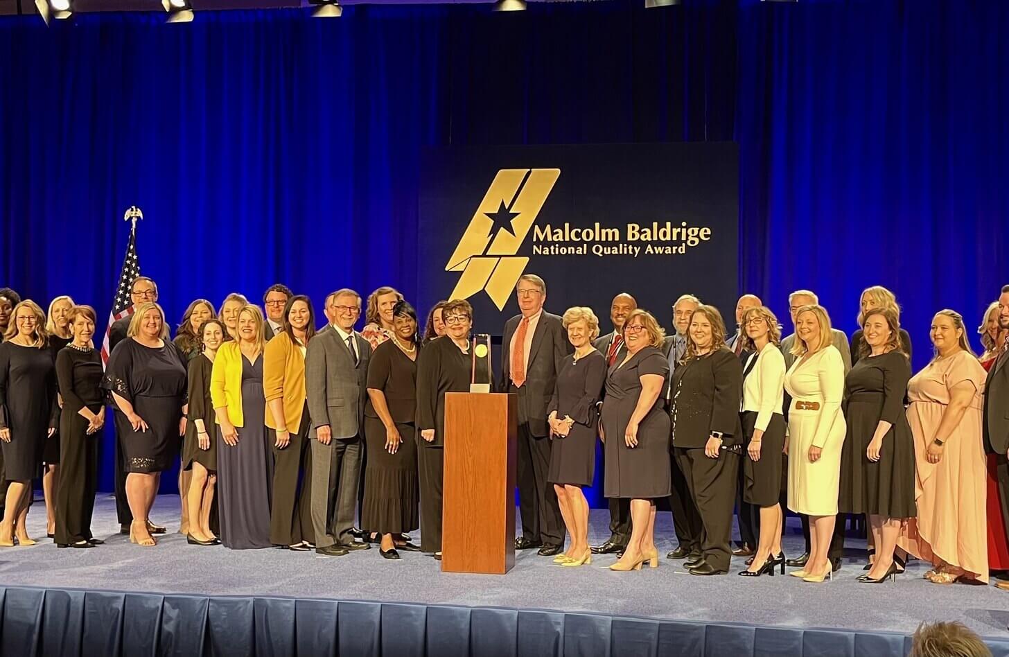 Mid-America Transplant staff stand on a stage in Washington DC