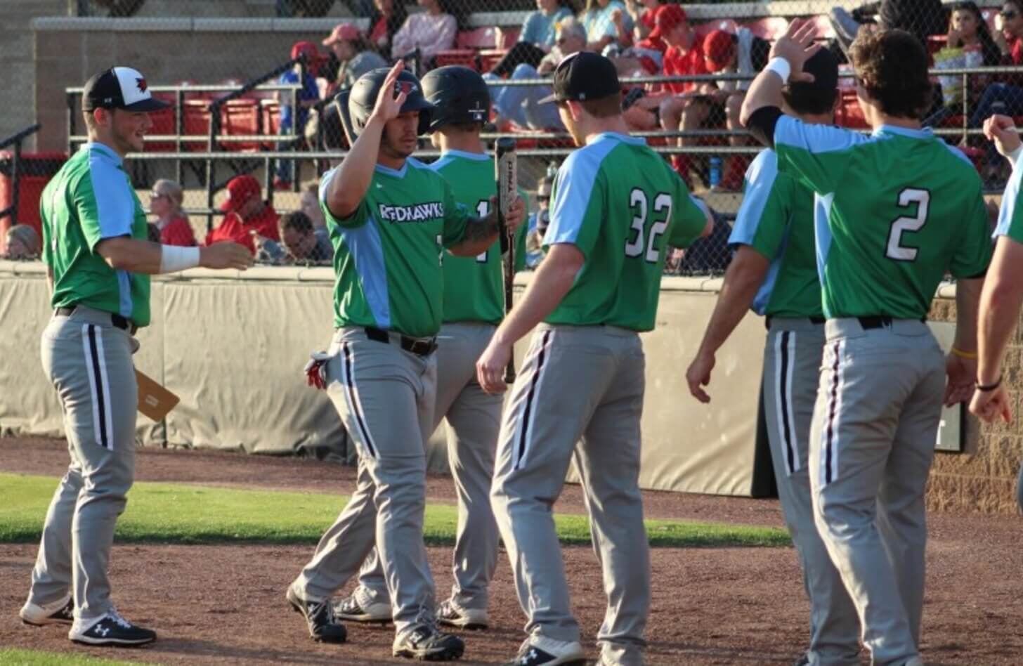 SEMO Players exchange high fives in their blue and green Donate Life Month jerseys