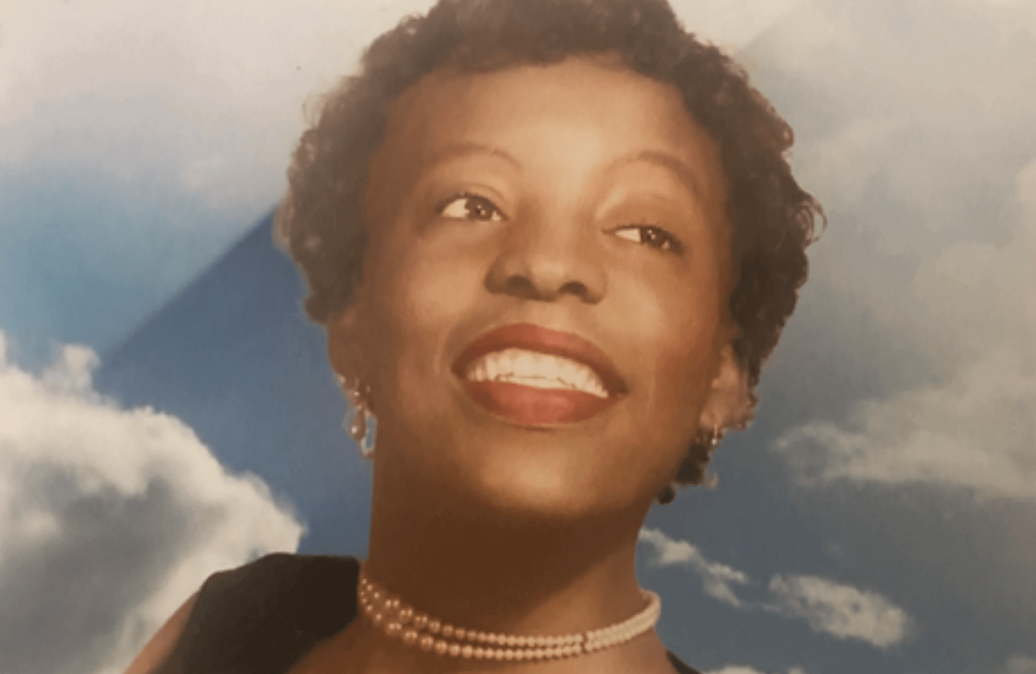 Delores Johnson, as pictured on her funeral announcement. She is gazing skyward to the right.