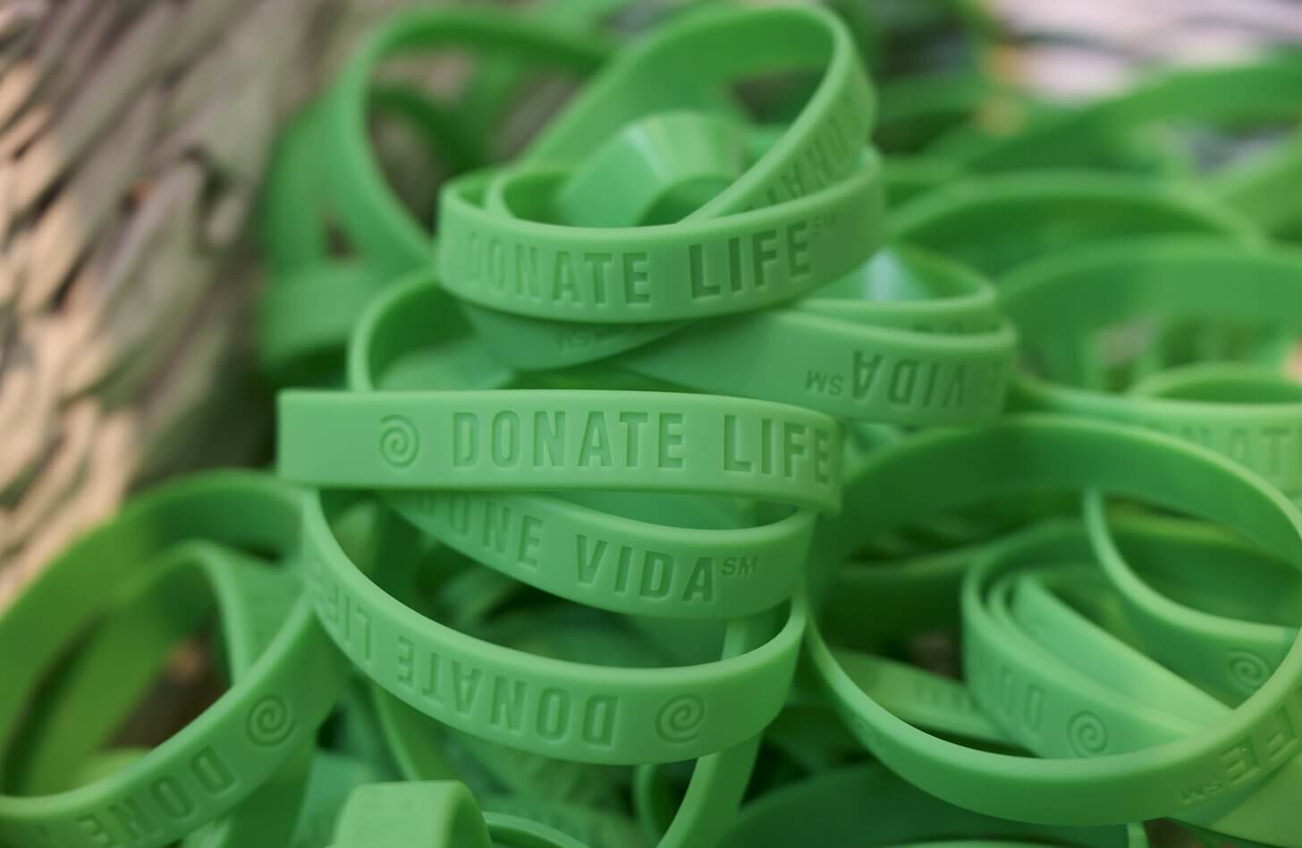 A pile of green "Donate Life" wristbands