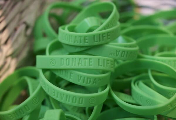 A basket of green bracelets
