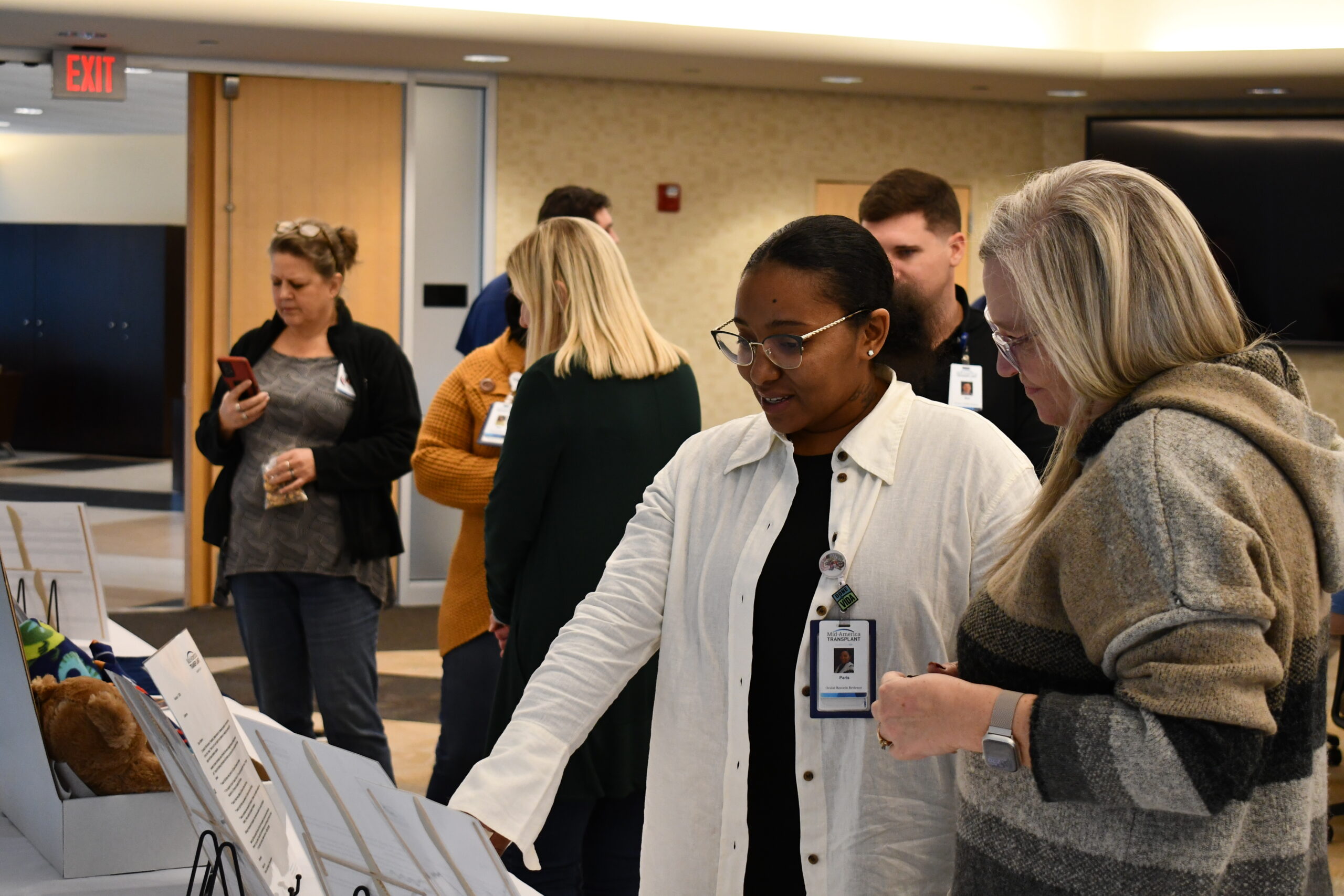 Two employees point at a display